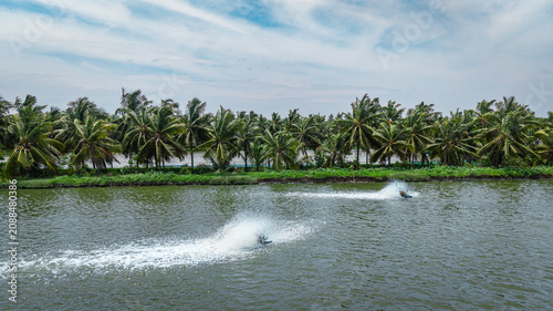 Fotografie Aerial view of prawn farming ponds with green vegetation and water channels