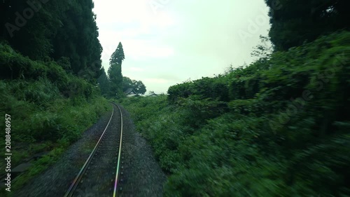 Point of view The train driving on railway line entered to dark tunnel 