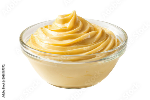 Creamy yellow sauce in glass bowl isolated on transparent background.