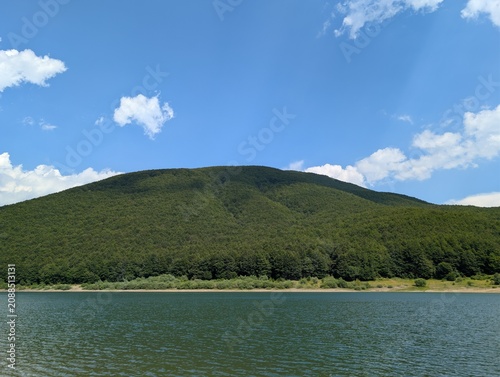 Fotografie Mountain lake surrounded by green beech forest in the Apennines, Italy