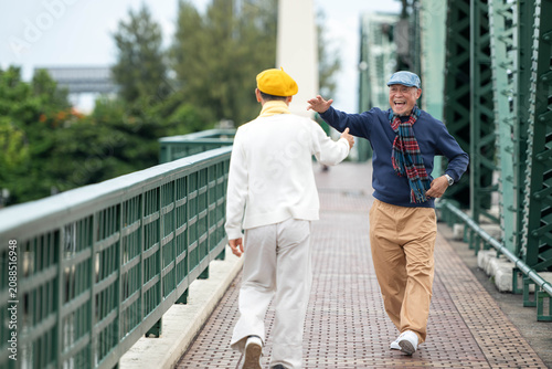 Photography Happy senior LGBTQ couple reuniting and greeting each other while traveling toge
