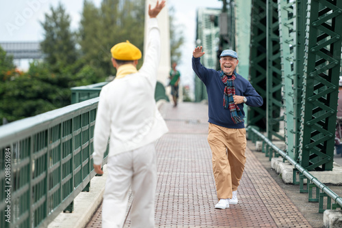 Canvastavla Happy senior LGBTQ couple reuniting and greeting each other while traveling toge