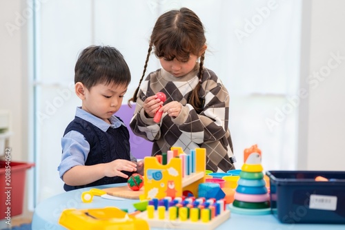 Obraz na płótnie Children play with toys in a classroom during the morning hours on a weekday