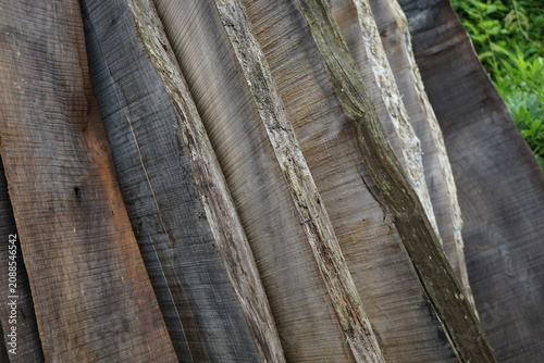 Fotografie Stack of rough sawn wooden planks with natural wood grain texture