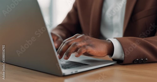 Business professional typing on modern laptop keyboard
