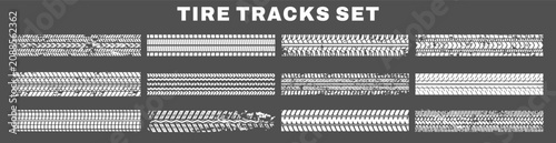 Grunge tire tread and skid patterns. Distressed wheel prints on black background.