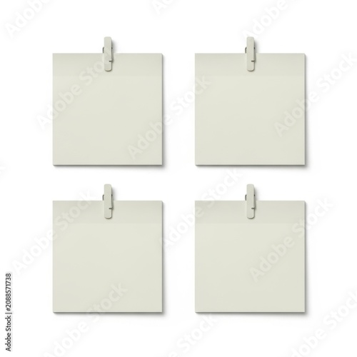 Four blank white notepads attached with silver clips on a plain background