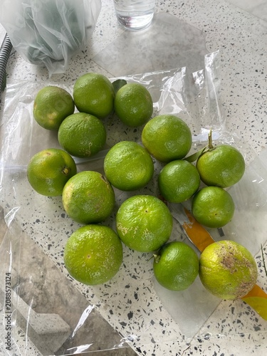 limes and lemons. Lime tree. Lime fruit. Green lime. Citrus fruit. Tropical fruit. Fruit tree. Orchard. Fresh lime. Organic farming. Agriculture. Nature. Garden.