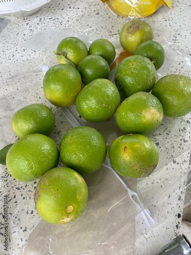 limes and lemons. Lime tree. Lime fruit. Green lime. Citrus fruit. Tropical fruit. Fruit tree. Orchard. Fresh lime. Organic farming. Agriculture. Nature. Garden.
