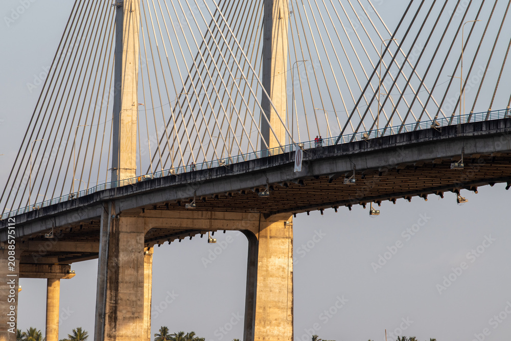Fototapeta premium Cable-stayed bridge with concrete pylons and stay cables at dusk.