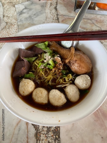 Beef noodle soup. Thai noodle soup. Thai food. Asian food. Braised beef. Beef meatballs. Noodles. Hot broth. Chopsticks. Homemade food. Bowl of noodles. Comfort food.