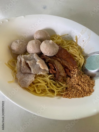 egg noodles. beef noodle soup. beef meatballs. braised beef. thai noodles. noodle bowl. asian food. comfort food. street food. homemade food. food photography. hot soup. savory meal. restaurant food. 
