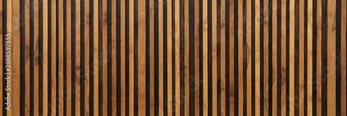 Abstract decorative wooden wall paneling with alternating light and dark vertical slat stripes pattern.