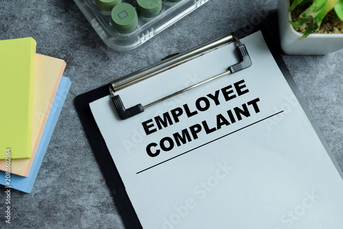 Konstfotografi Concept of employee complaint write on clipboard isolated on Wooden Table