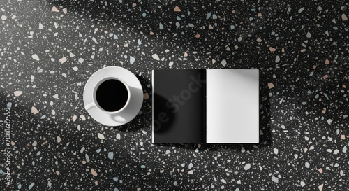 Minimalist Coffee And Open Book Still Life On Terrazzo Desk