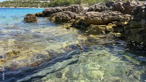 Exploring rocky shores and clear waters in a coastal location under bright sunlight