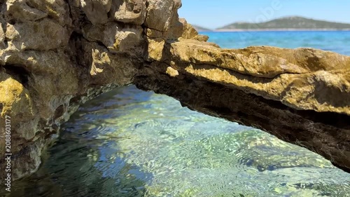 Explore clear water and rocky formations in a coastal area during bright daylight in this natural setting by the sea