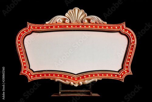 Vintage illuminated marquee sign with red bulbs and an ornate gold frame against a black background, offering blank copy space for entertainment or event branding.