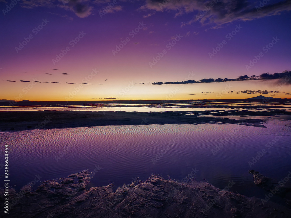 Fototapeta premium Stunning purple and orange twilight sky reflecting on a serene lake in South America landscape