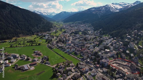 Aerial panoramic view above the downtown around the city Davos in Switzerland on a sunny summer afternoon. 