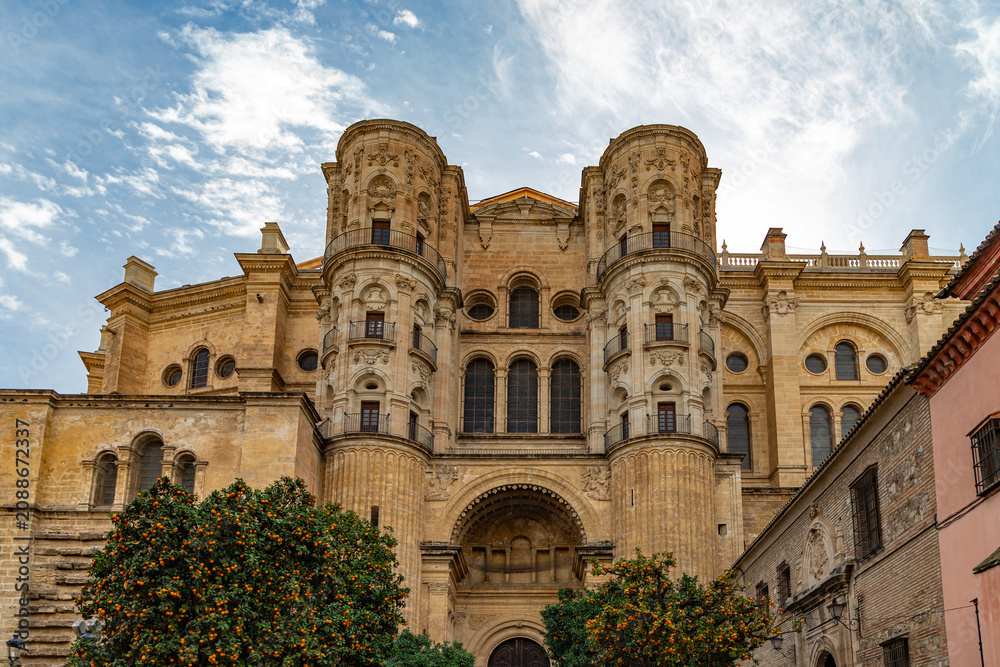 Fototapeta premium View at the Malaga Cathedral or Santa Iglesia Catedral Basílica de la Encarnación, an iconic national landmark ,16th-century baroque facade