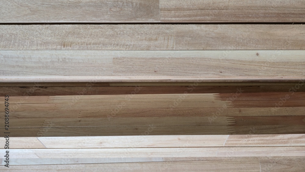 Fototapeta premium Natural lumber planks stacked horizontally texture background. Close-up of raw wooden framing boards stacked together, showcasing organic timber lines and material setup.