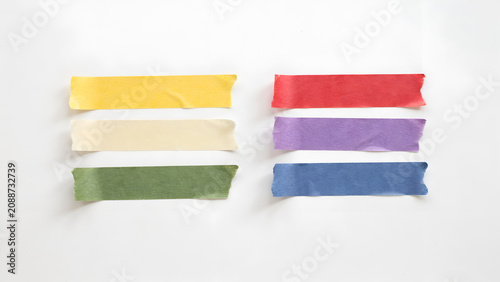 Six strips of colorful masking tape arranged in two columns on white