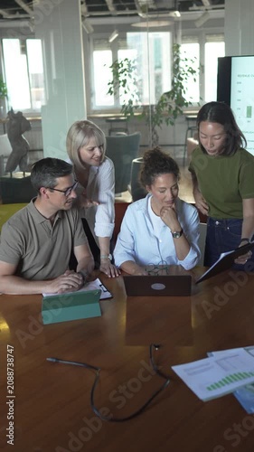 Diverse business team discussing project in modern office meeting room