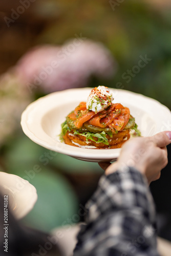Poached egg on zucchini fritters with fresh herbs
Healthy brunch with poached egg and zucchini pancakes
Gourmet vegetable fritters served in restaurant