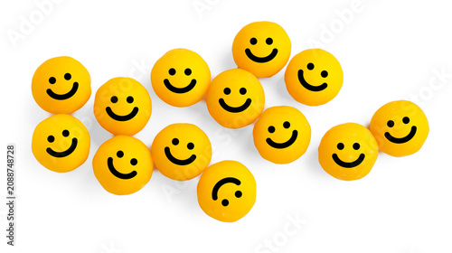 Bild auf Leinwand Yellow antidepressant pills with smiley faces on white background, top view