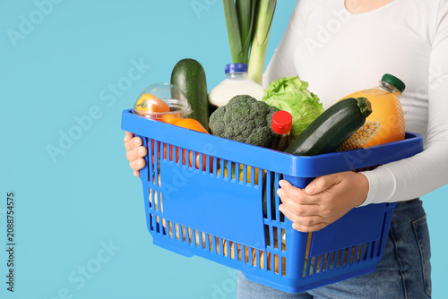 Woman holding shopping bask...