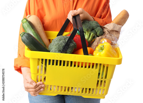 Woman holding yellow shoppi...