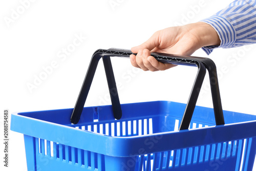 Photos Female hand with blue shopping basket on white background