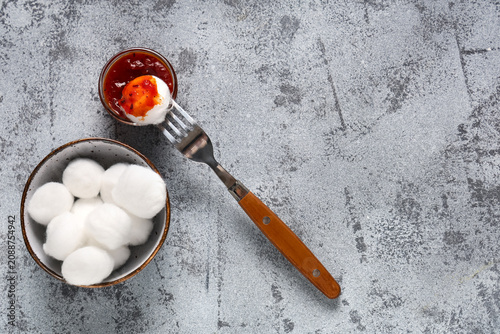 Bowl of cotton balls with f...