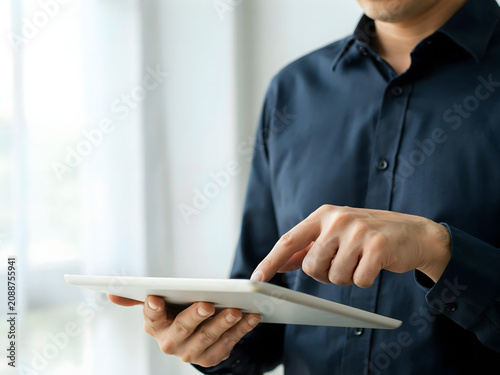 Man using tablet for business or technology concept, indoor scene