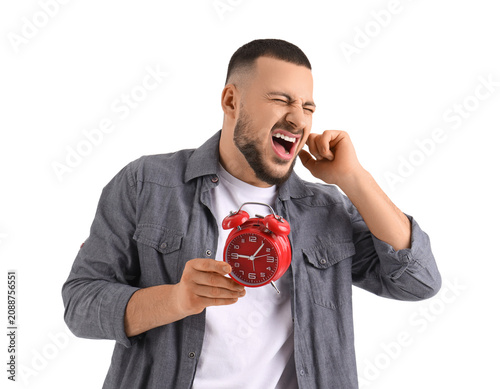 Young man with alarm clock ...