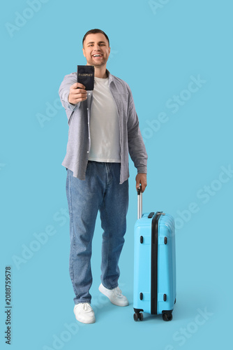Male tourist with suitcase ...