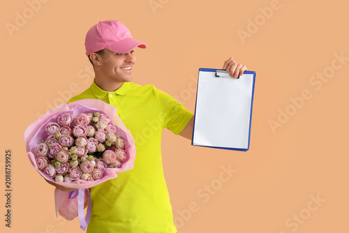 Male courier with bouquet o...