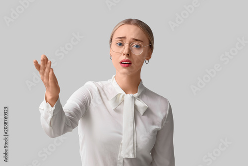 Worried young woman on ligh...