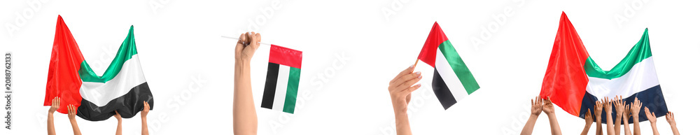 Fototapeta premium Hands holding and waving United Arab Emirates flags