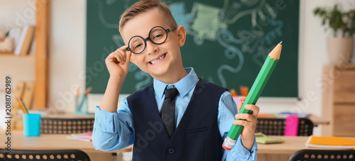 Smiling boy in glasses hold...