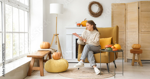 Young woman reading book in...