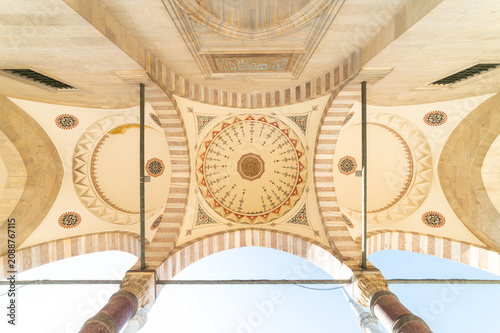 horizontal photo of a mosque small domes from the main entry.