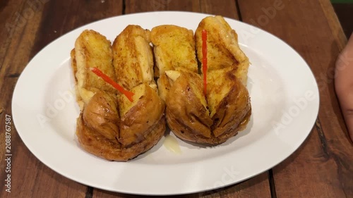Serving a Plate of Golden Fried Crescent Rolls with Decorative Straws