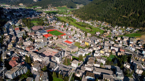 Foto Aerial panoramic view above the downtown around the city Davos in Switzerland on a sunny summer afternoon