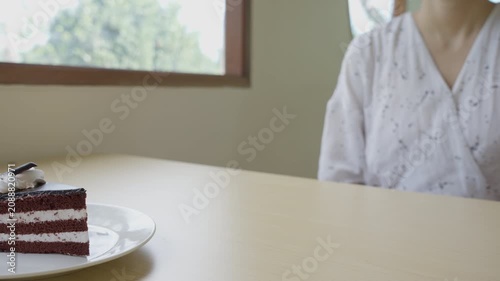 Beauty slim female body confuse chocolate cake. Woman in restaurant achieves weight loss goal for healthy life, crazy about thinness, thin waist, nutritionist. Diet, body shape.