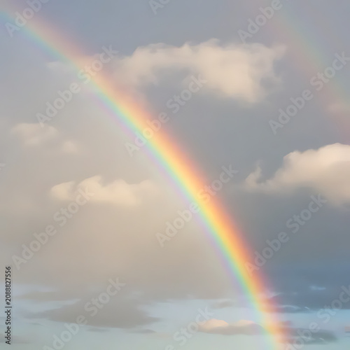 Rainbow appearing through clouds