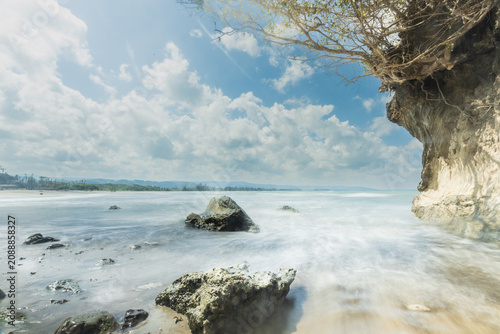 The sky blazes blue, with the midday sun beating down fiercely upon Sumba—upon the sea and the land alike. The tide starts to fall, and the force of the waves is frozen in time through long-exposure s