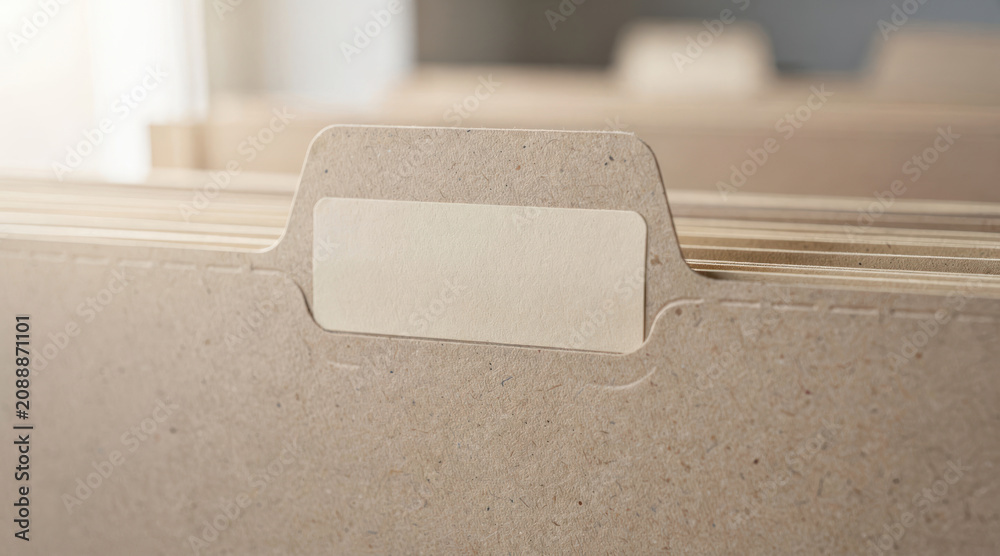 Obraz premium Close up of blank label on brown paper file folders for document storage in office drawer.