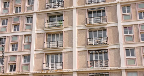 Exterior view of high rise residential apartment building facade with balconies.
